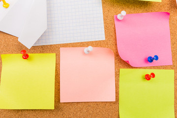 Fototapeta premium Cork board with pinned colored blank notes - Image .