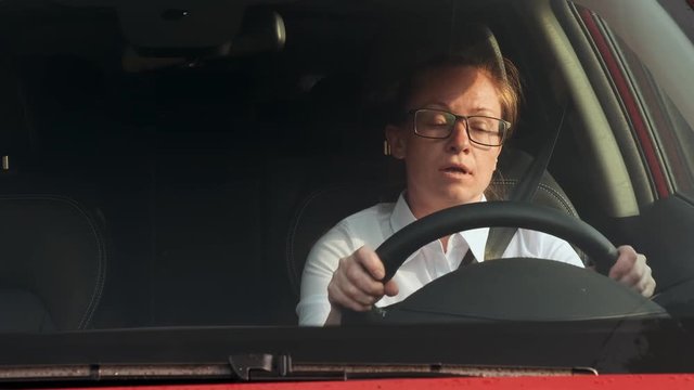 tired girl driver falls asleep while driving car.