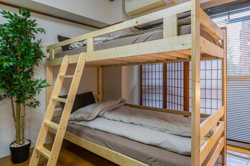 Brown double-decker bed in a small bedroom