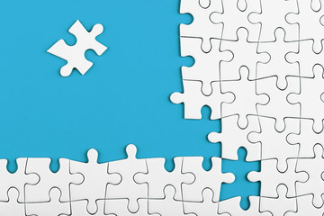 Fototapeta premium Unfinished white puzzle pieces on blue background