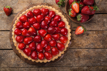 delicious strawberry tart on wooden background