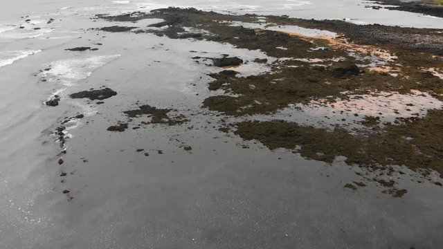 Aerial footage over Ytri Tunga beach in Iceland. Showing parts of the shallow beach famous for its many seals and low waterlevels.