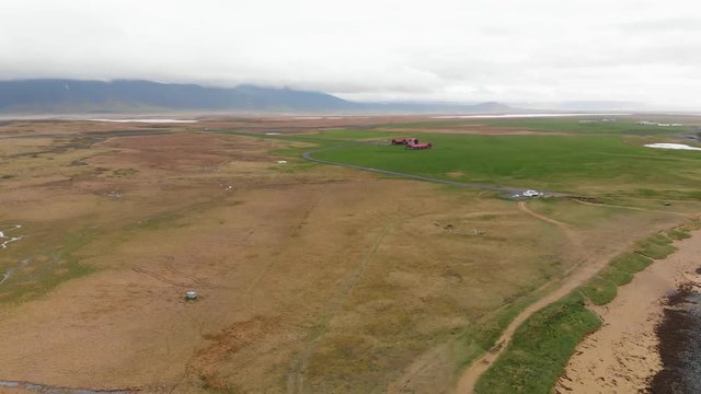 Aerial footage over Ytri Tunga beach in Iceland. Showing the parkinglot, the beach and the ocean.