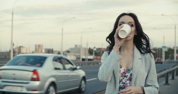 woman drinking coffee from cup