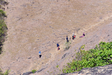 Indonesian people climbing to Bukit Merese Hills in Lombok Island, Indonesia