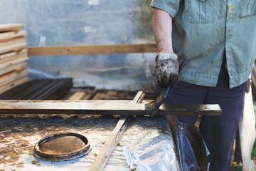 a man paints a paint board with a brush