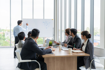Businesspeople discussing together in conference room during meeting at office.