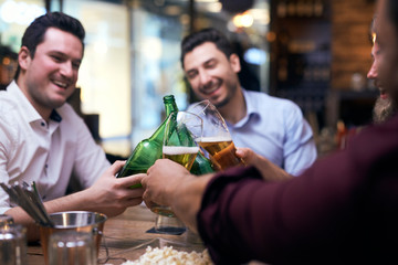 Men making a cheers in the pub