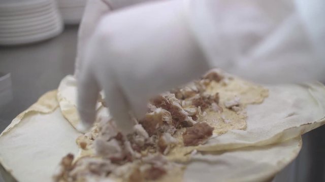 Chef prepares fried chicken sadwich, close up