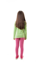 Rear view of little girl with long hair looking at wall. Isolated on white background
