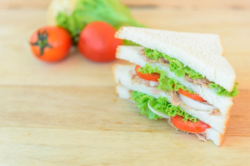 sandwich tuna salad with the ingredients on wood plate