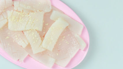 raw squid sliced on pink plate