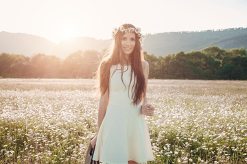 Fototapeta na wymiar Beautiful girl in daisy field. Summer sunset