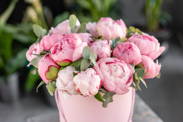 Pink peonies on the old grey table. Beautiful peony flower for catalog or online store. Floral shop concept . Beautiful fresh cut bouquet. Flowers delivery