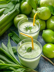 Close Up smoothie. Green apples, celery, ramson and limes on a concrete background. Detox program, diet plan, weight loss.