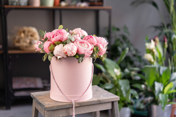 Pink peonies on the old grey table. Beautiful peony flower for catalog or online store. Floral shop concept . Beautiful fresh cut bouquet. Flowers delivery