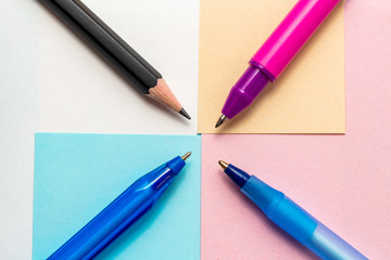 Colorful blank sheets of paper notes with blue and pink pens and pencil composition Back to school concept with stationery office supplies on a blue wooden background close-up top view