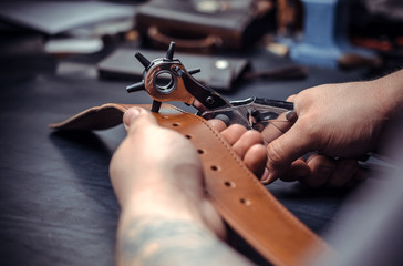 Tanner works as an artisan at the leather studio