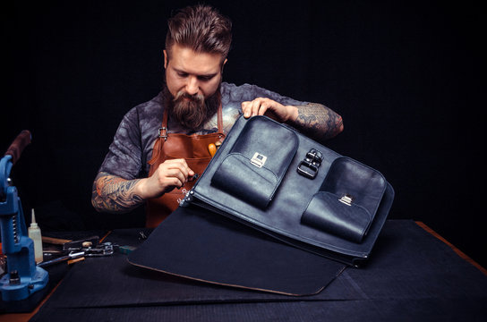 Leather Artist processes a workpiece from leather at his studio