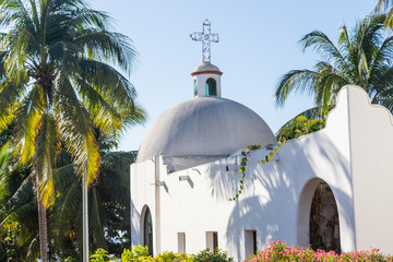 Fototapeta na wymiar Typical white Mexican church. White Catholic Church in a tropical resort. 
