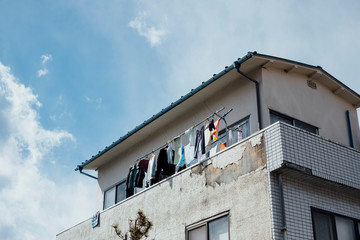 Fototapeta na wymiar apartment hanging washed clothes in Japan