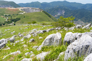 Fototapeta na wymiar View of rocky hill, limestone quarry and sky in Fukuoka prefecture, JAPAN. It is Hiraodai of karst plateau.