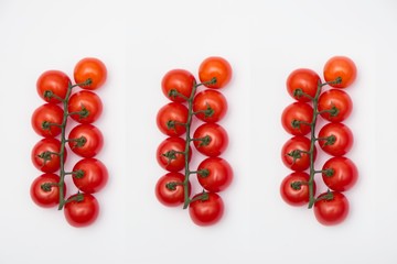 Ripe fresh Juicy organic cherry tomatoes on branch isolated on a white background.