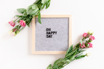 Quote Oh happy day. Composition with letter .board and eustoma flowers on white background