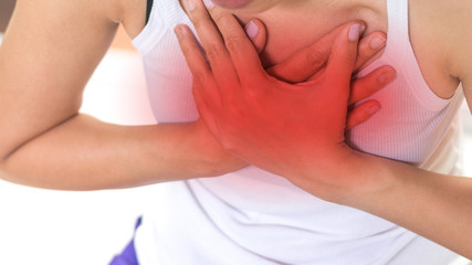 Fototapeta na wymiar Woman's hand on chest with red spot as suffering on chest pain. Female suffer from heart attack,Lung Problems,Myocarditis, heart burn,Pneumonia or lung abscess, pulmonary embolism day