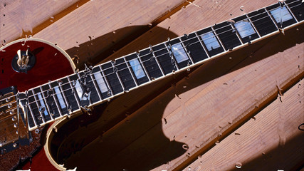 electric guitar behind the glass with water drops . closeup