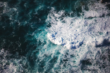Sea water with foam waves, shot from above abstract natural background and texture
