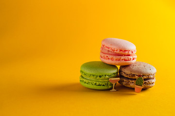 macaroon arranged in beautiful composition on a  yellow background