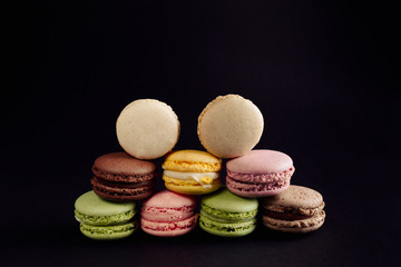 macaroon arranged in beautiful composition on a black background