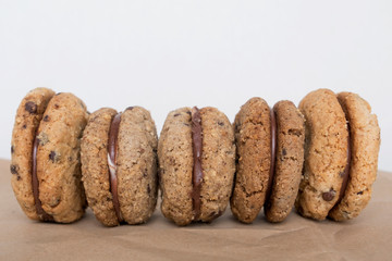 Delicious hazelnut and almond sandwich biscuits with chocolate, ganache and gianduja filling. Baci di dama or Ladys kisses are italian cookies from Piedmont.