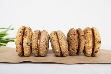Delicious hazelnut or almond sandwich biscuits with chocolate, ganache and gianduja filling. Baci di dama (Lady's kisses) - italian cookies from Piedmont.