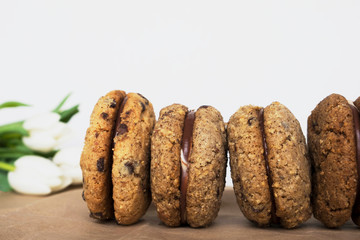 Delicious hazelnut almond sandwich biscuits with chocolate, ganache and gianduja filling. Baci di dama (Ladys kisses) italian cookies from Piedmont.