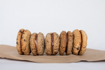 Delicious hazelnut and almond sandwich biscuits with chocolate, ganache and gianduja filling. Baci di dama or Ladys kisses are italian cookies from Piedmont.