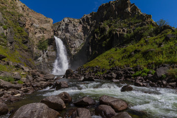 Waterfall in Altay mountains. Beautiful nature landscape. Popular touristic distination.