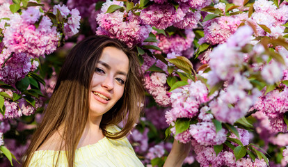 Fototapeta premium Soft and tender. Gorgeous flower and female beauty. Woman in spring flower bloom. Natural cosmetics for skin. Floral paradise. Girl in cherry blossom flower. Sakura tree blooming. Cosmetics concept