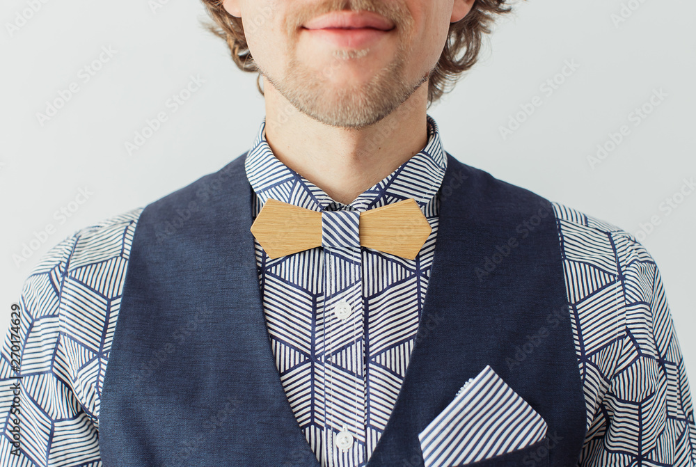 Wall mural man with beard in a wooden bowtie