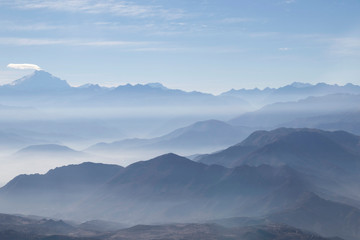 Fototapeta na wymiar Misty blue Andean mountain landscape background