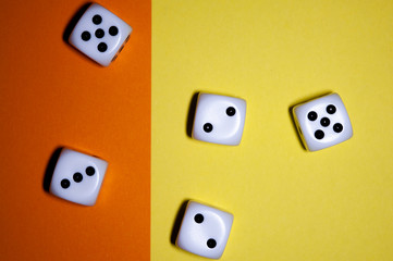 Dice flat lay on Yellow and orange background