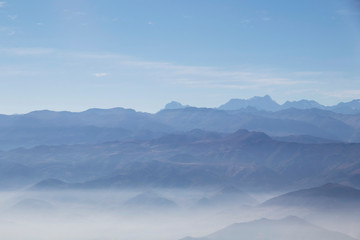 Misty blue Andean mountain landscape background