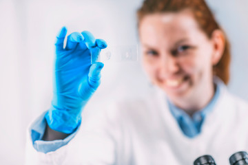 Archaeologist with Ancient Tooth Root Microscope Slide