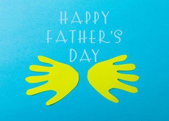 Obraz premium Happy fathers day sign on paper laid on blue backround.