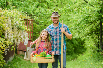 father and daughter on ranch. family farm. ecology. Gardening tools. little girl and happy man dad. earth day. spring village country. Making a beautiful flower bunch