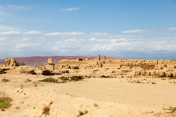 Fototapeta na wymiar Ruins of Gaochang, Turpan, China. Dating more than 2000 years, Gaochang and Jiaohe are the oldest and largest ruins in Xinjiang. The Flaming mountains are visible in the background