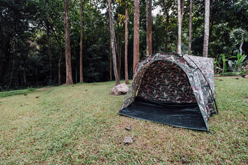 camouflage tent in forest