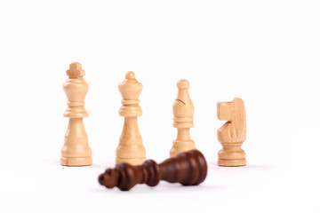 Row of white wooden chess pieces. Teamwork and cooperation, loser black king, Isolated on white background.