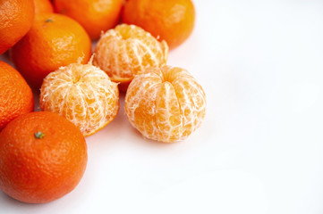 peeled tangerines on a white background. skins. slices